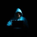 a man sitting in the dark