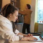 shallow focus photo of woman using a laptop